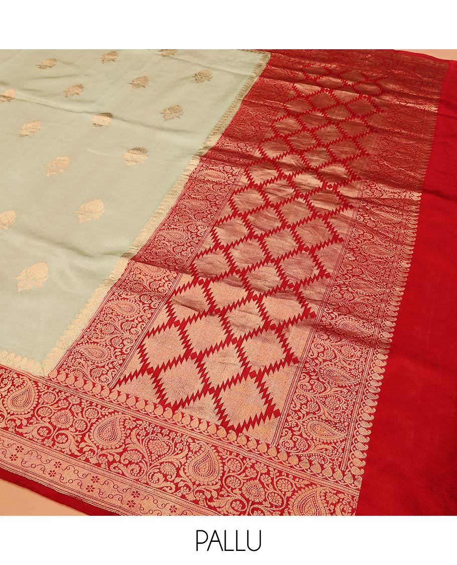 Light Sandal Raw Mango Silk Saree Beautified with Buttas, Featuring a Contrast Paisley Zari-Designed Border, a Zari-Elevated Jaal Pallu, Paired with a Contrast Blouse