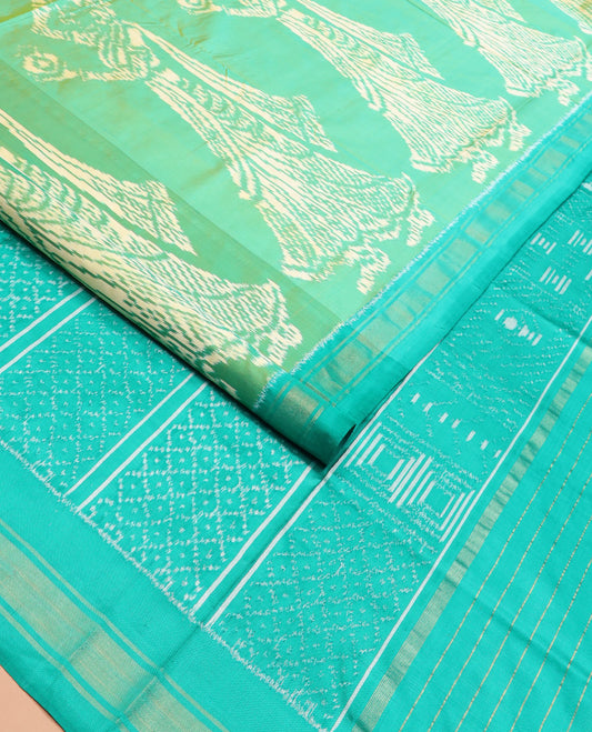 Green Ikkat Silk Saree Beautified with Human Figurines, Complemented by a Contrast Border, Hazily Woven Pallu of Geometric Patterns, and a Contrast Blouse