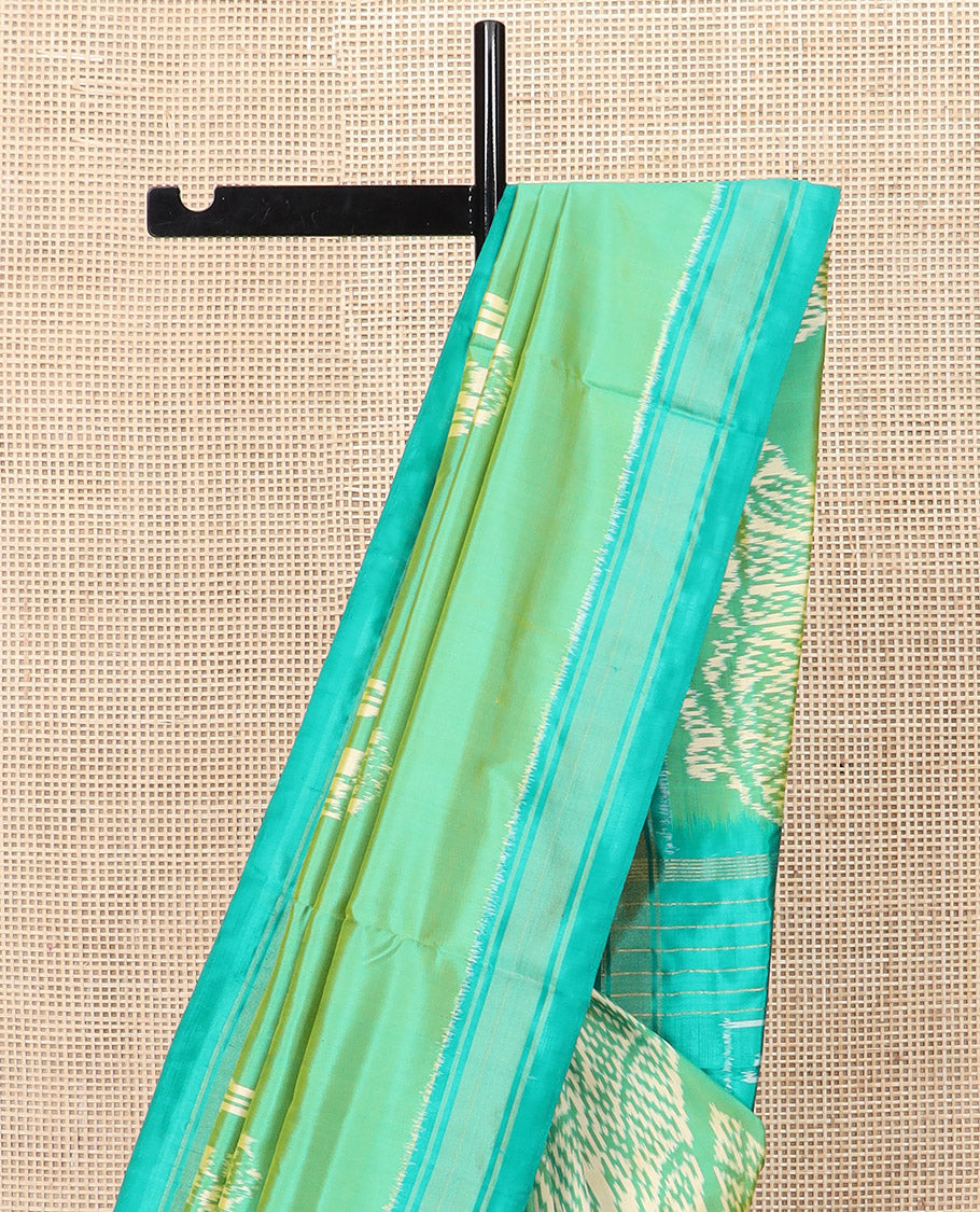 Green Ikkat Silk Saree Beautified with Human Figurines, Complemented by a Contrast Border, Hazily Woven Pallu of Geometric Patterns, and a Contrast Blouse