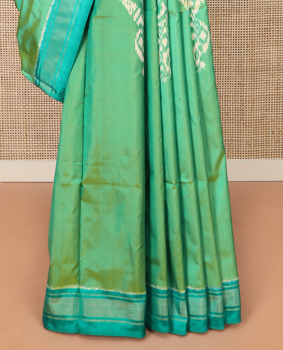 Green Ikkat Silk Saree Beautified with Human Figurines, Complemented by a Contrast Border, Hazily Woven Pallu of Geometric Patterns, and a Contrast Blouse