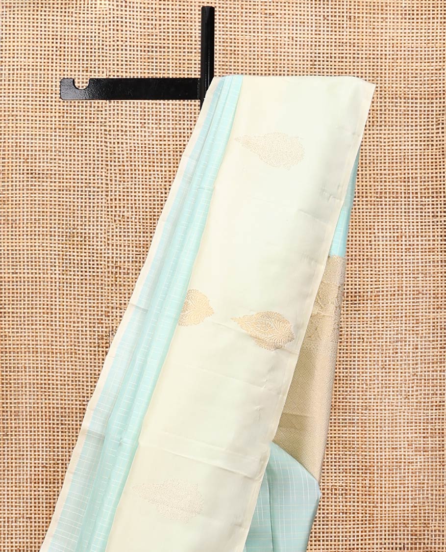 Pale Blue Kanchipuram Silk Saree, Sparsely Woven with Checks, Complemented by a Contrast Zari Buttas Woven Border, Jaal Pallu, and Contrast Blouse