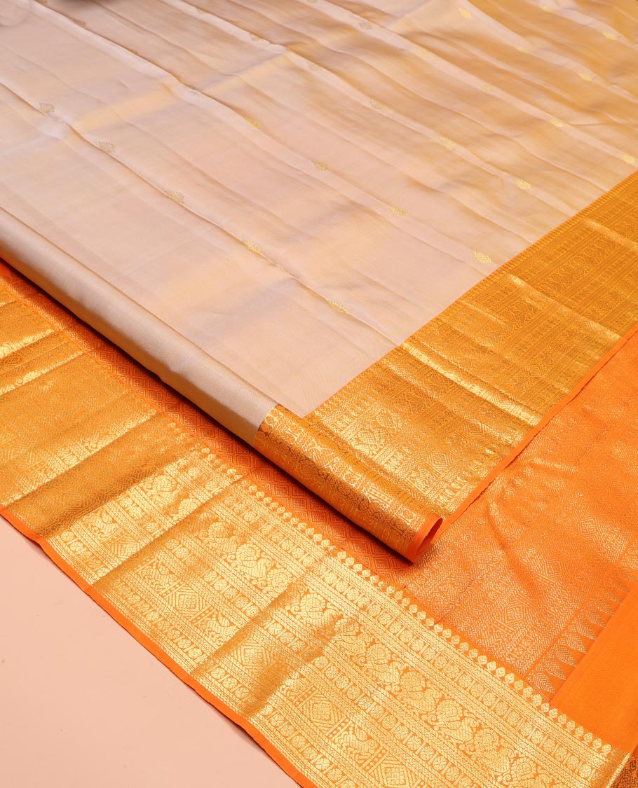 Sandal Kanchipuram Silk Saree, Finely Crafted with Zari Buttas All Over Its Body, Complemented by a Contrast Border of Thilakam Mokku, Poun, Neli, Mayil, and Kuthirai Designs, Pallu of Jaal Designs, and Paired with a Contrast Blouse
