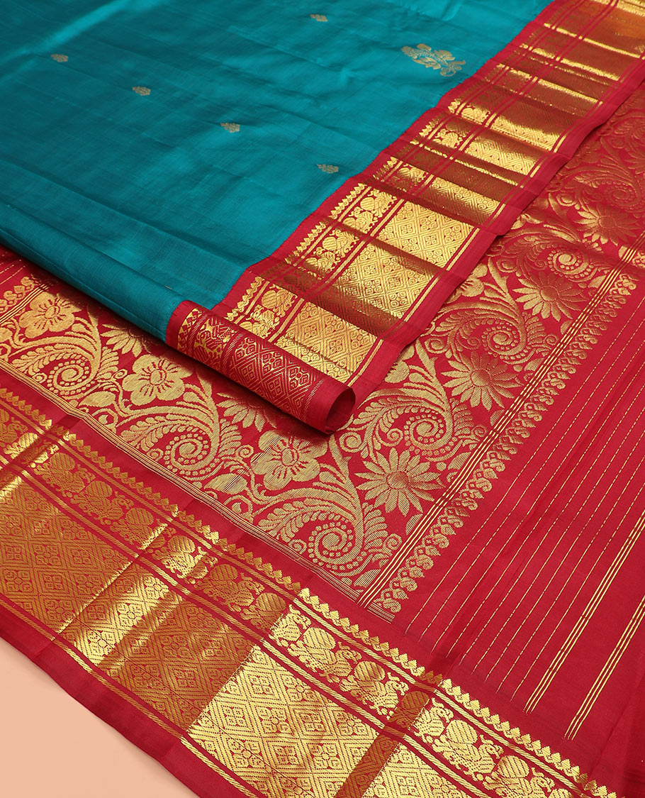 Blue zari buttas Kanchipuram silk saree, contrast korvai border of thilakam mokku, mayil, and diamond designs, and floral jaal pallu