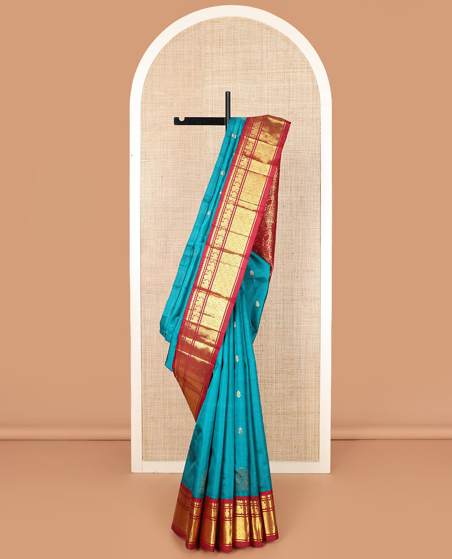 Blue zari buttas Kanchipuram silk saree, contrast korvai border of thilakam mokku, mayil, and diamond designs, and floral jaal pallu