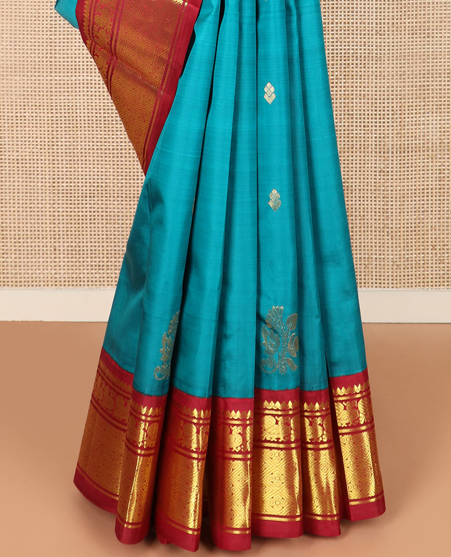 Blue zari buttas Kanchipuram silk saree, contrast korvai border of thilakam mokku, mayil, and diamond designs, and floral jaal pallu