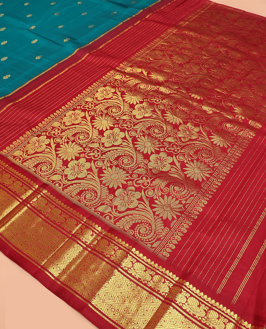 Blue zari buttas Kanchipuram silk saree, contrast korvai border of thilakam mokku, mayil, and diamond designs, and floral jaal pallu