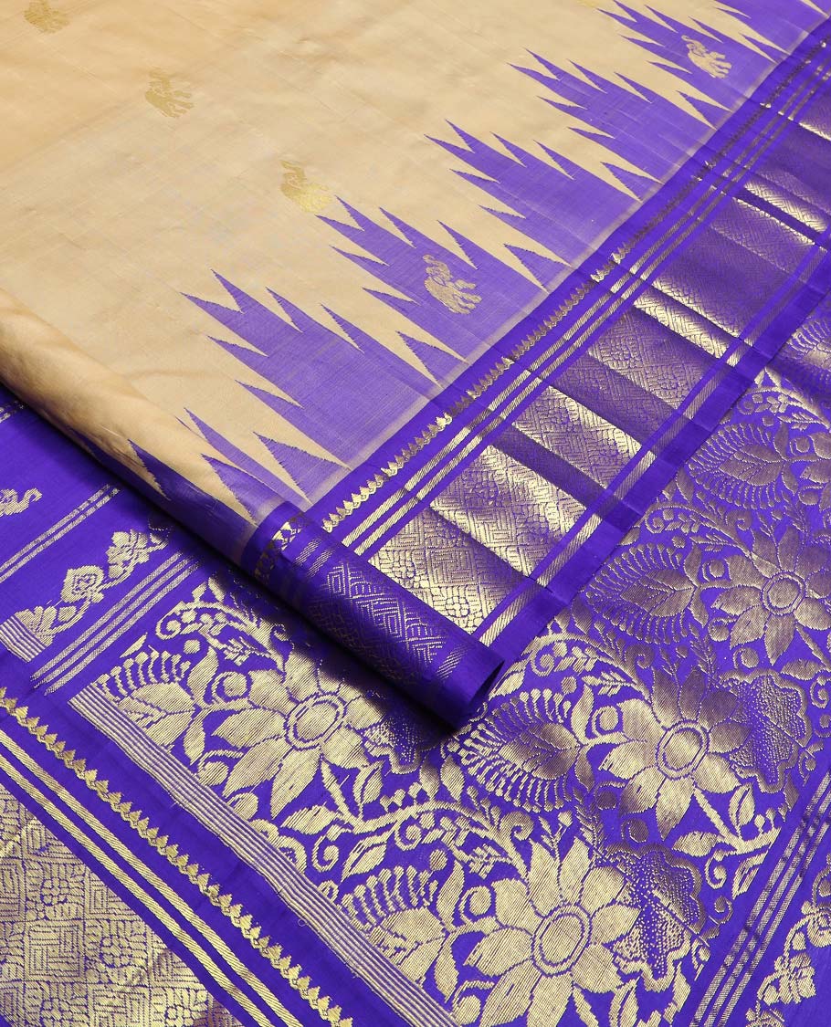 Light sandal yaanai buttas Kanchipuram silk saree, contrast one-sided thazampoo rekku border of thilakam mokku, banaras, and jaal designs, and floral jaal pallu