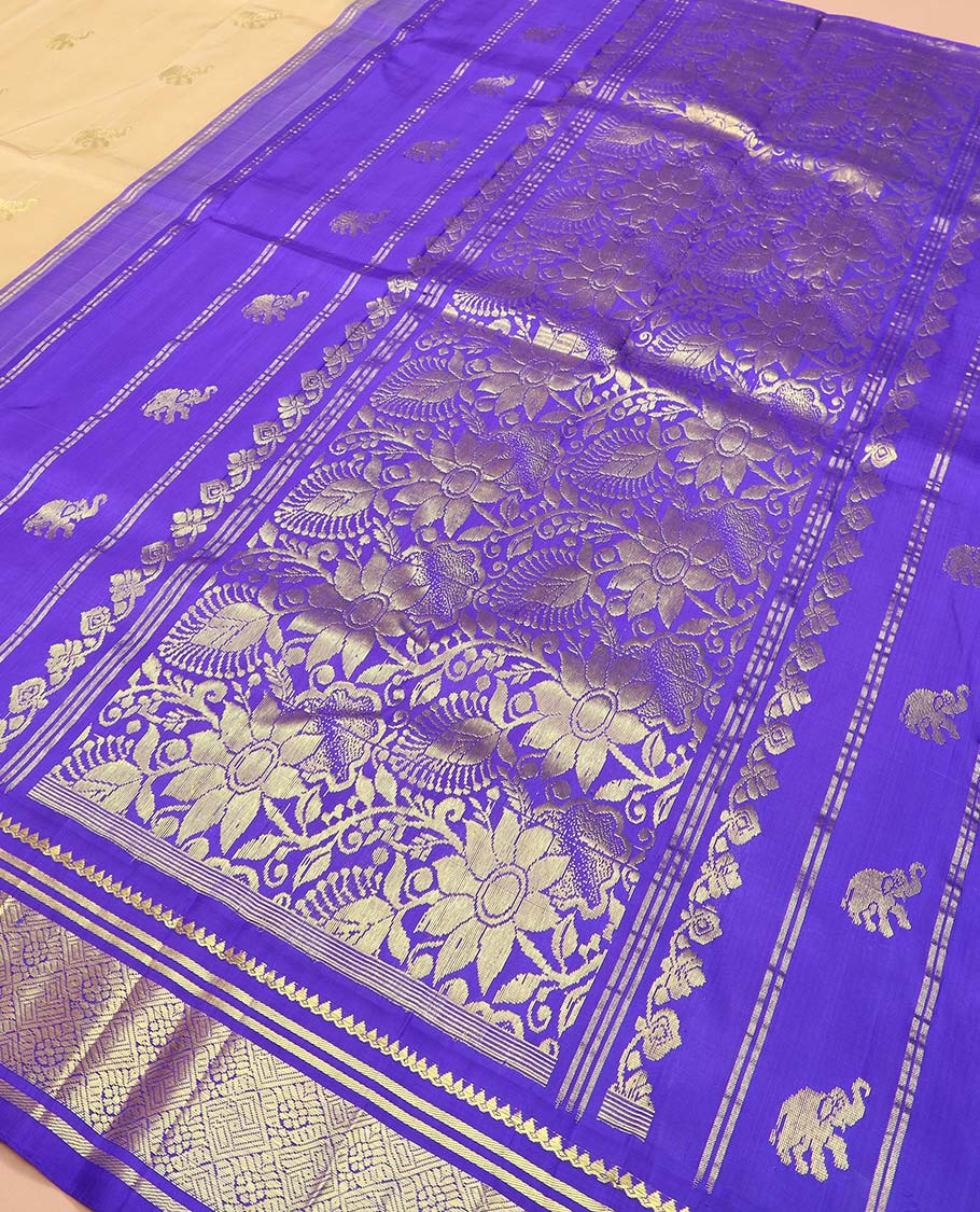 Light sandal yaanai buttas Kanchipuram silk saree, contrast one-sided thazampoo rekku border of thilakam mokku, banaras, and jaal designs, and floral jaal pallu