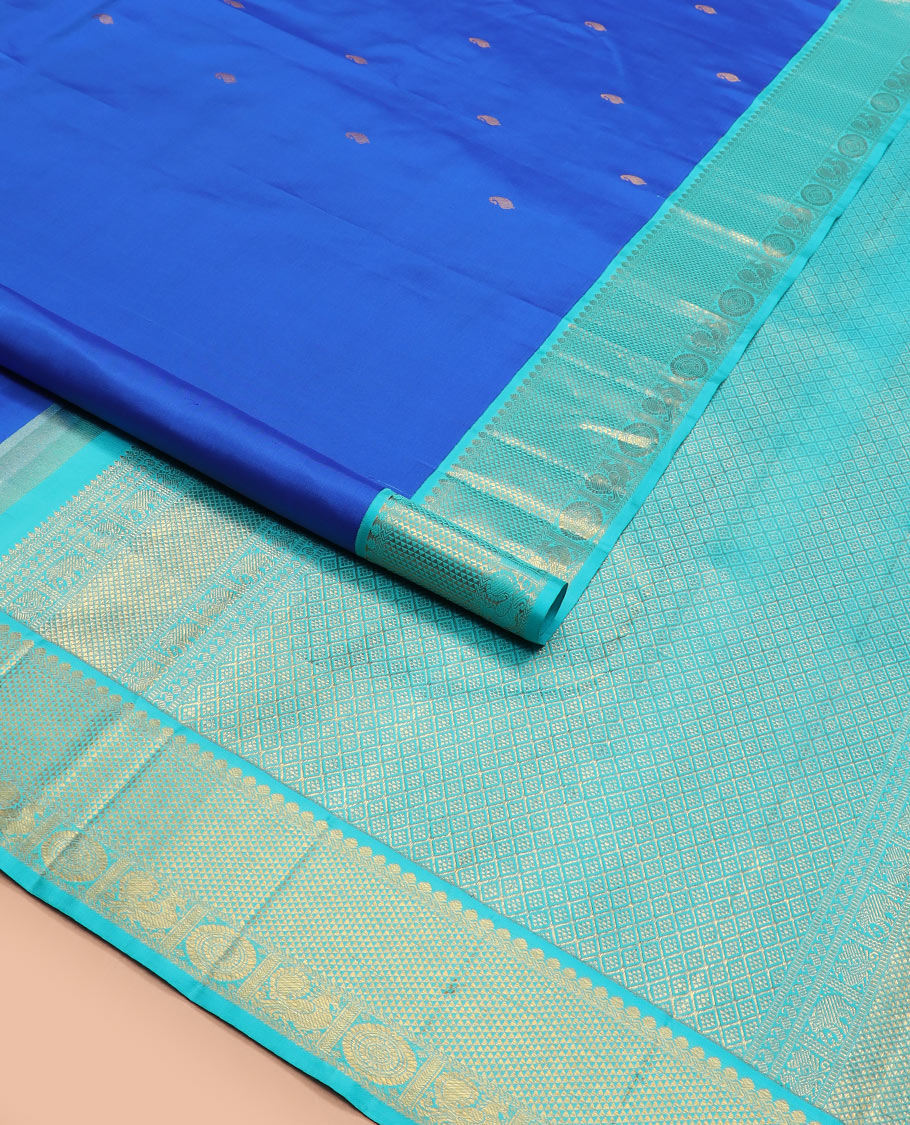 Blue vanki manga buttas Kanchipuram silk saree, contrast korvai border of salngai, banaras, ara maadam, and anna chakram designs, and jaal pallu