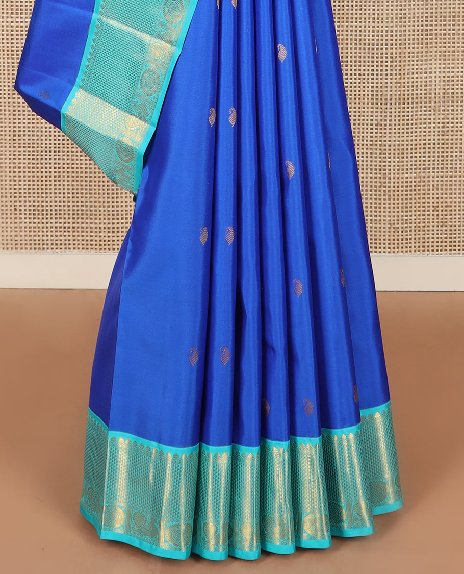 Blue vanki manga buttas Kanchipuram silk saree, contrast korvai border of salngai, banaras, ara maadam, and anna chakram designs, and jaal pallu