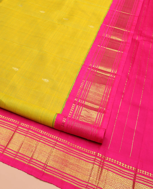 Green Kanchipuram Silk Saree Sparsely Sparkled with Zari Buttas All Over Its Body, Complemented by Contrast One-Sided Korvai Border of Paneer Sombu, Banaras, Muthu, and Mayil Kann Designs, Pallu of Zari Designs, and Comes Without a Blouse
