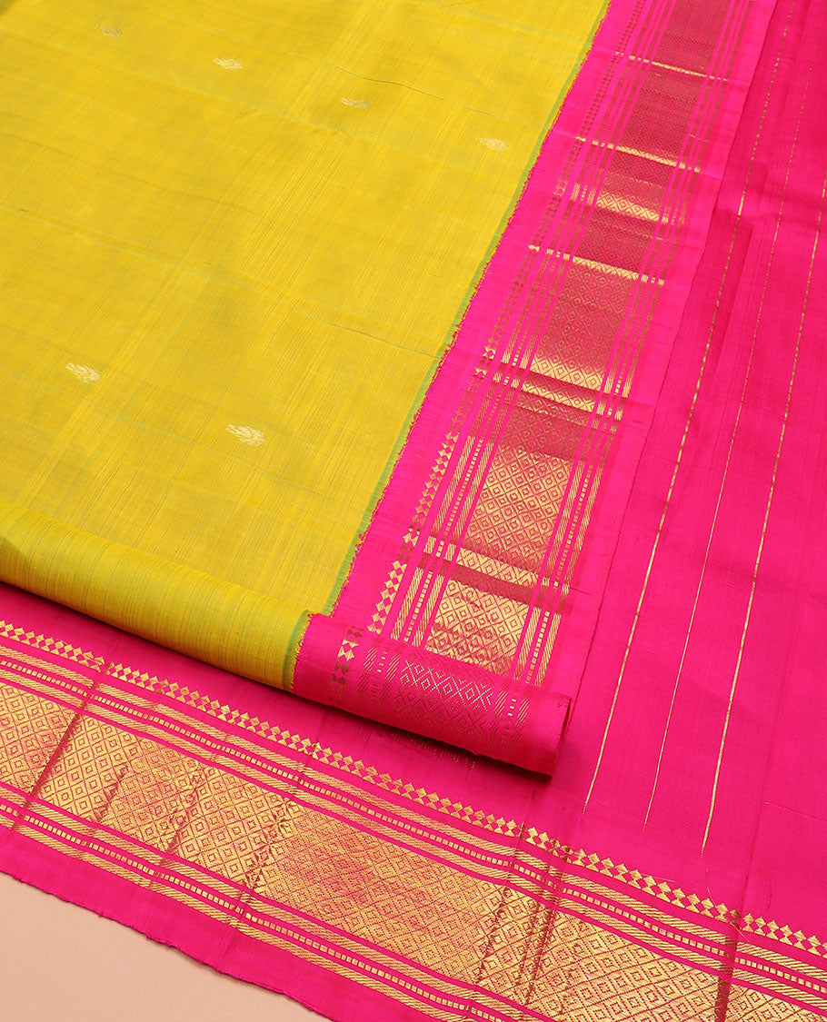 Green Kanchipuram Silk Saree Sparsely Sparkled with Zari Buttas All Over Its Body, Complemented by Contrast One-Sided Korvai Border of Paneer Sombu, Banaras, Muthu, and Mayil Kann Designs, Pallu of Zari Designs, and Comes Without a Blouse