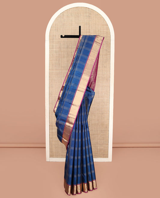 Blue Kanchipuram Silk Saree, Ornamented with Zari Checked Design on Its Body, Complemented by a Contrast Border of Manga, Rekku, Cross Kamalam, and Mayil Kann Designs, Grand Jaal Pallu, and Paired with a Contrast Blouse