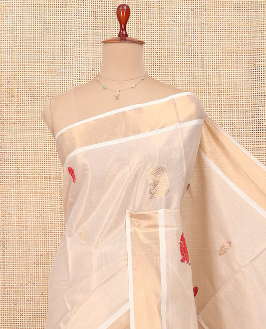 Cream Kerala Cotton Saree, Accentuated with Thread and Zari Buttas All Over Its Body, a Zari Bavanji Border, Pallu of Elephant Designs, and Paired with a Matching Blouse