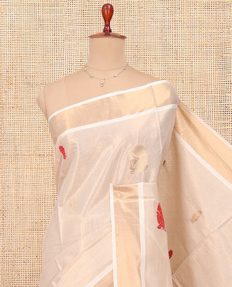 Cream Kerala Cotton Saree, Accentuated with Thread and Zari Buttas All Over Its Body, a Zari Bavanji Border, Pallu of Elephant Designs, and Paired with a Matching Blouse
