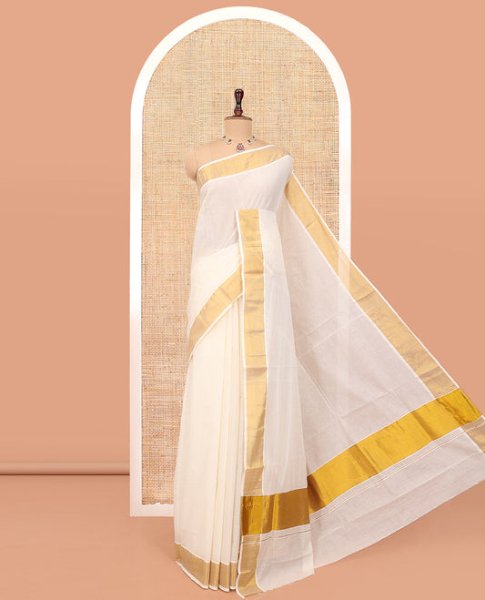 Cream Plain Kerala Cotton Saree, a Subtle Bavanji Border, Gleaming Zari Pallu, and Is Paired with a Matching Blouse