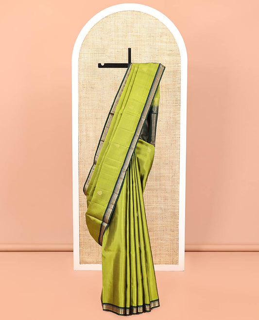 Green Mayuri Soft Silk Saree, Beautifully Bedecked with Zari Buttas All Over Its Body, Complemented by Contrast Border of Ara Bogudi, Muthu, Banaras, and Kathir Designs, Pallu of Neli, Muthu, and Banaras Designs, and Paired with Contrast Blouse