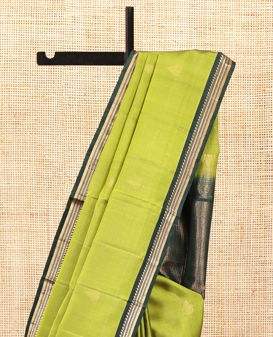 Green Mayuri Soft Silk Saree, Beautifully Bedecked with Zari Buttas All Over Its Body, Complemented by Contrast Border of Ara Bogudi, Muthu, Banaras, and Kathir Designs, Pallu of Neli, Muthu, and Banaras Designs, and Paired with Contrast Blouse