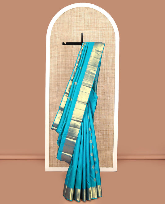 Blue Parampara Silk Saree, Adorned with Zari Buttas and Embossed Texture On Its Body, Highlighted by Zari Border of Thazampoo Rekku, Muthu, and Vanki Designs, Pallu Features Vanki Designs and Paired with a Matching Blouse