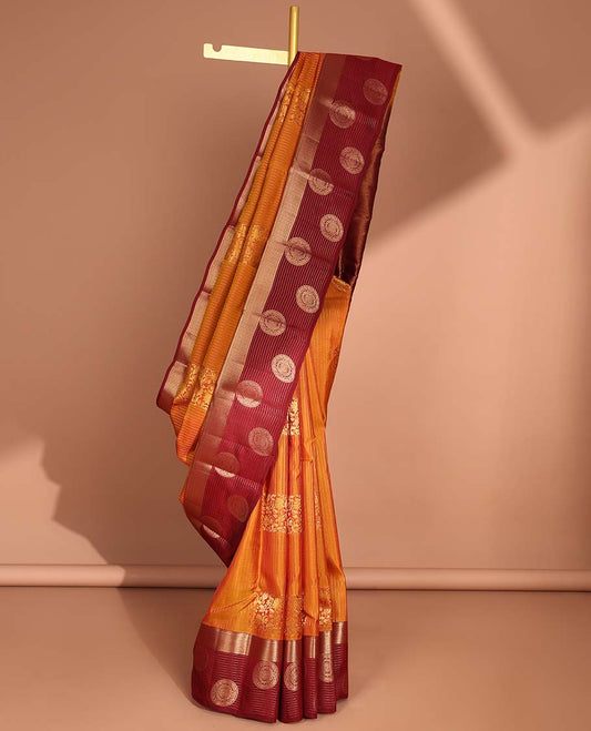 Orange striped, floral design vasundhara elite silk saree with contrast striped, round buttas border & floral zari design pallu
