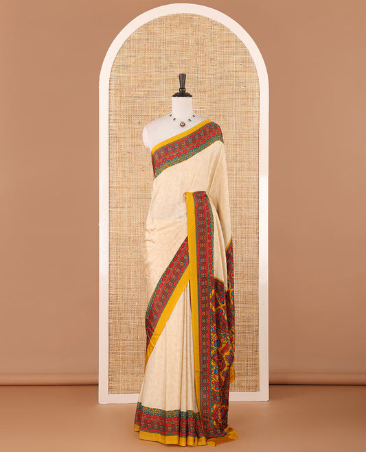 Cream leaf motifs printed crepe silk saree, contrast yellow printed blouse, kaleidoscope coloured intricately printed border & pallu
