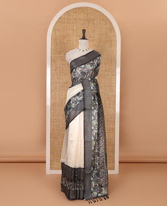 Cream plain tissue saree, contrast dobby-style zari buttas & kalamkari-style flora-fauna printed border & pallu