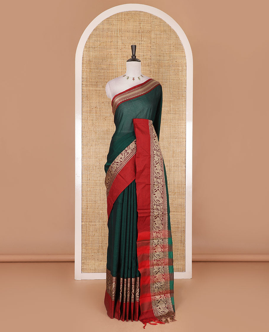 Green plain mercerised cotton saree, contrast traditional border of peacock, and elephant motifs, striped pallu, and a matching blouse