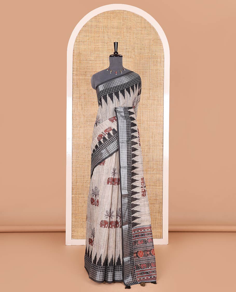 Chikku elephant motifs printed linen cotton saree, contrast temple printed checked border, ikkat style floral printed pallu, and a contrast floral printed blouse