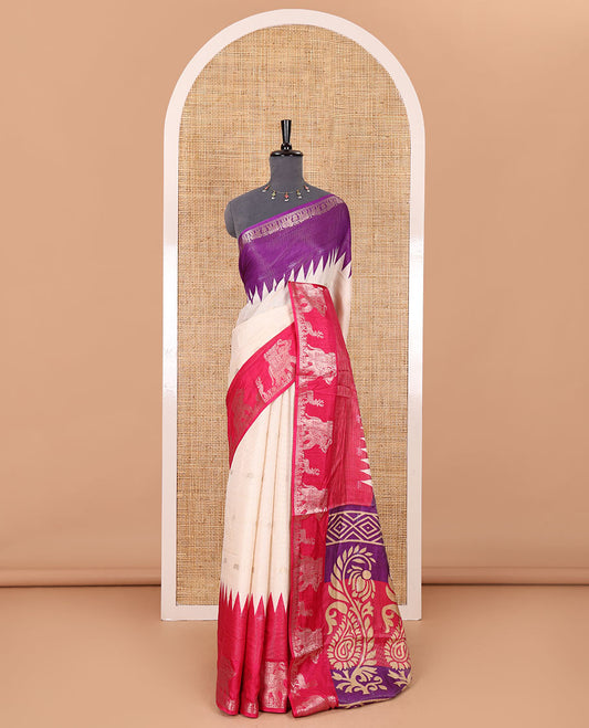 Half-white zari stripes and buttas dola silk saree, contrast pink-purple Ganga-Jamuna temple elephant motifs border, paisleys printed pallu, and contrast elephant buttas blouse