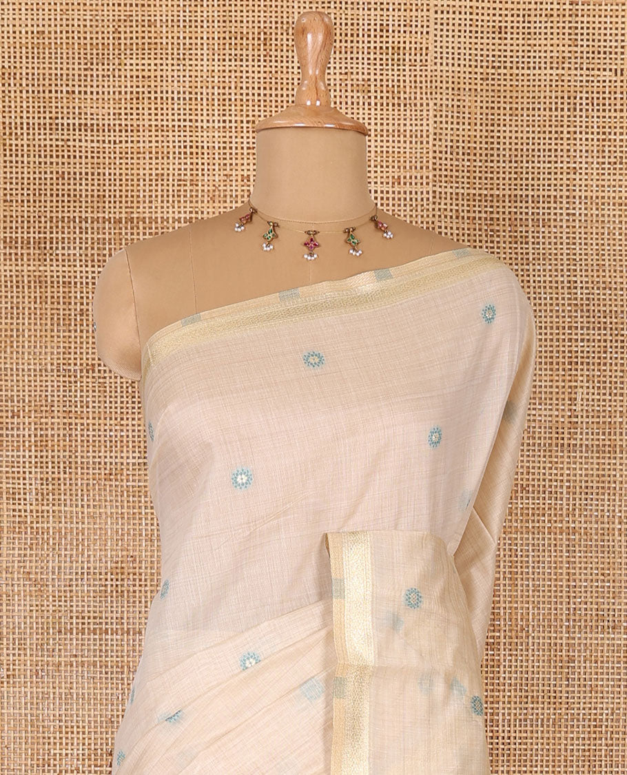 Cream resham thread and zari buttas Munga cotton saree, traditional gold zari border, tree motifs blue thread work pallu, and matching buttas blouse