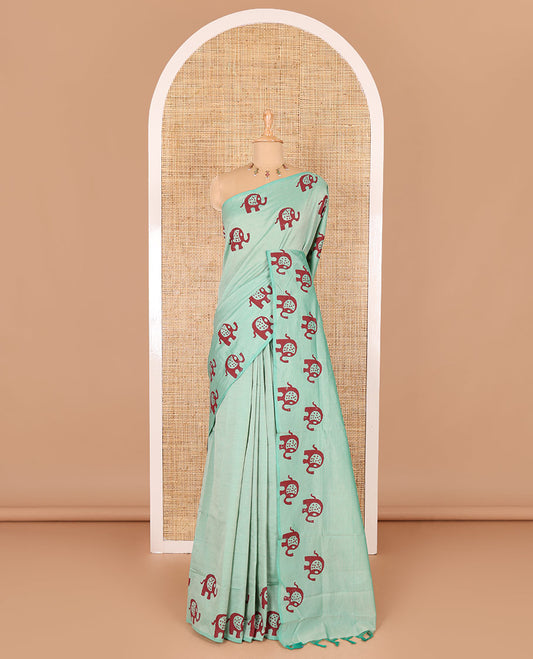 Sea green plain South cotton saree with elephant motifs block printed border, a matching blouse and a contrast floral motifs printed blouse
