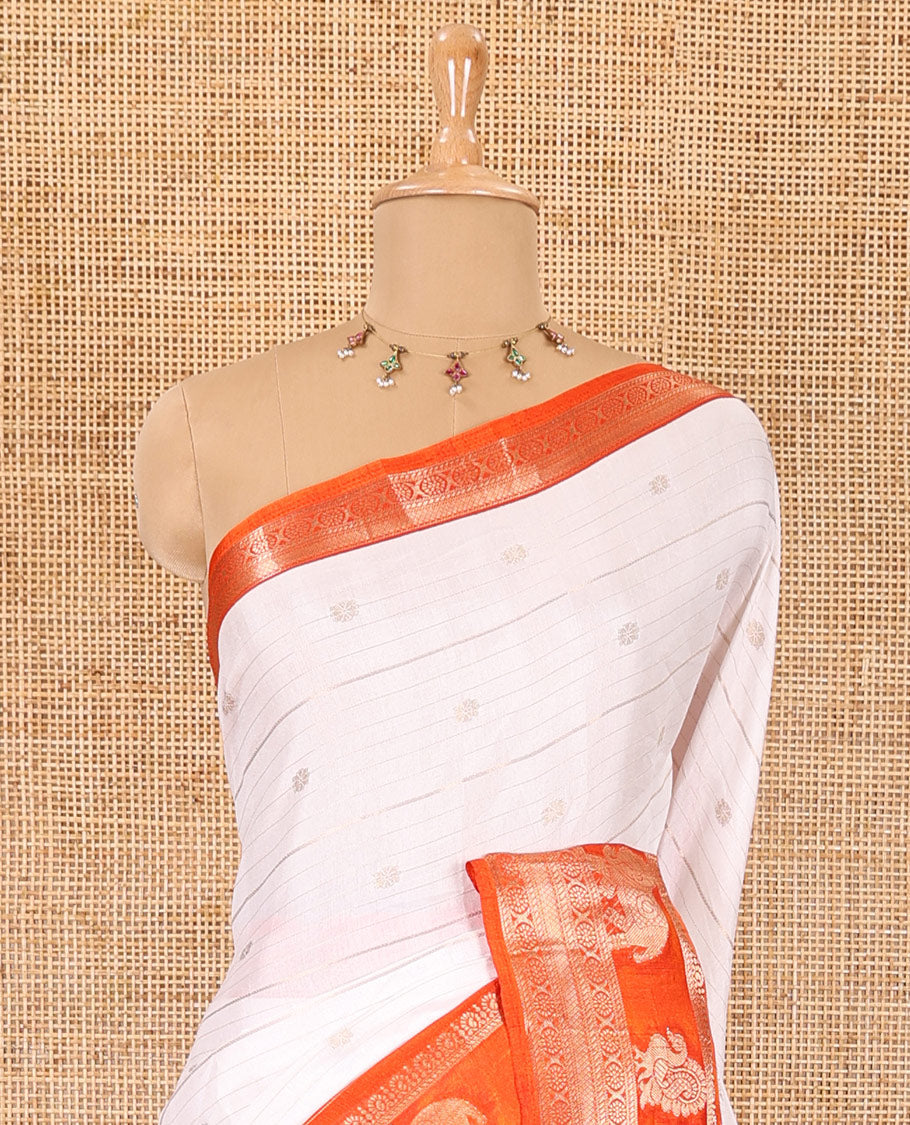 White zari buttas and striped dola silk saree, contrast traditional zari border of elephant and peacock buttas, zari design pallu, and a contrast floral print with zari work blouse