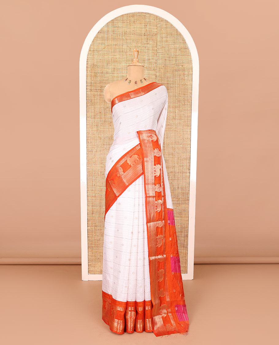 White zari buttas and striped dola silk saree, contrast traditional zari border of elephant and peacock buttas, zari design pallu, and a contrast floral print with zari work blouse