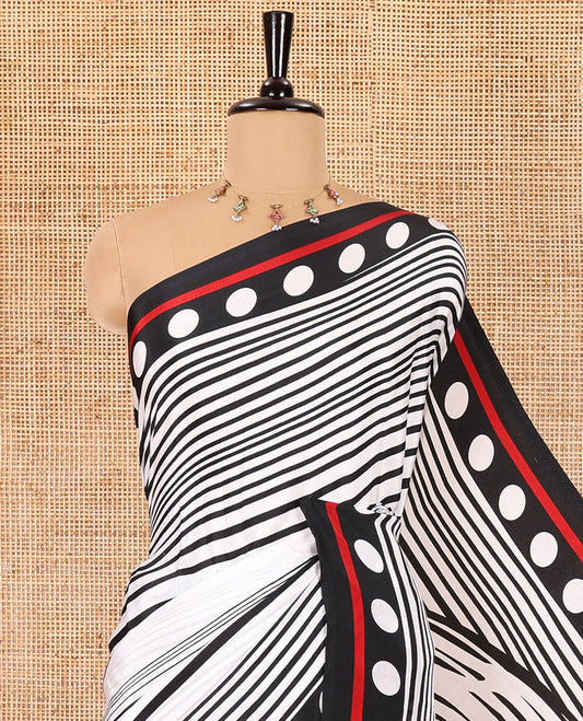 White and black horizontal stripes and wavy patterned crepe silk saree, small coin buttas printed blouse, big circle motifs printed pallu, and a plain blouse