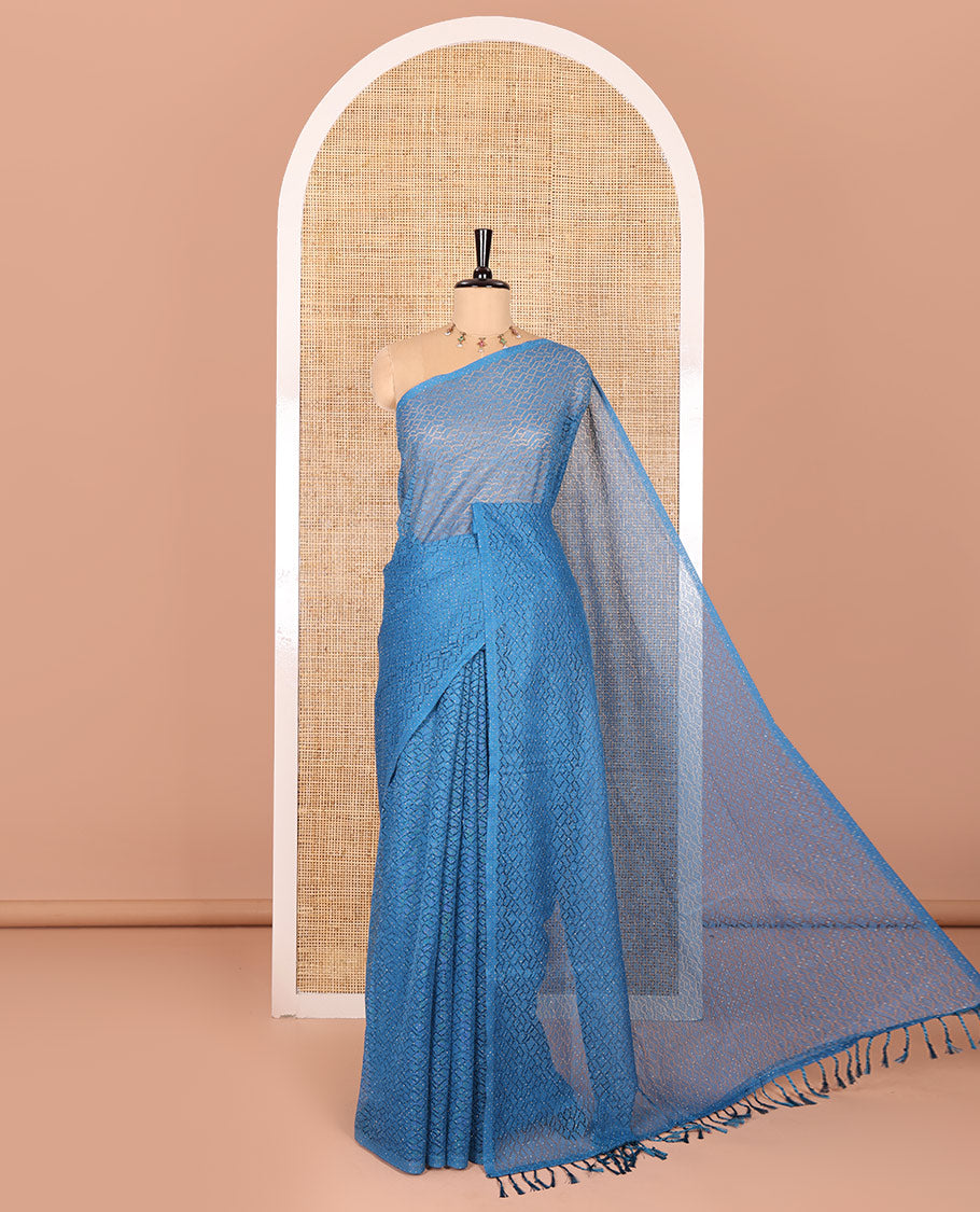 Borderless blue sparkling glitter russel net saree with self-pallu, and a contrast floral printed and zig-zag patterned blouse