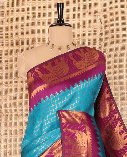 Peacock green checked design litchi saree, contrast temple elephant motifs border, geometric patterned pallu, and a contrast jacquard blouse