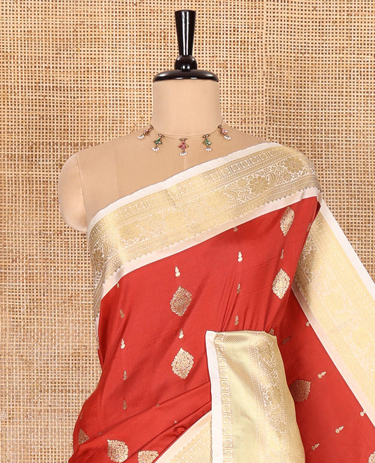 Red Soft Silk Saree Decked Up with Antique Zari Buttas, Complemented with a Contrast Traditional Zari Design Steeped Border, Adorned with Intricate Pallu, and a Contrast Blouse