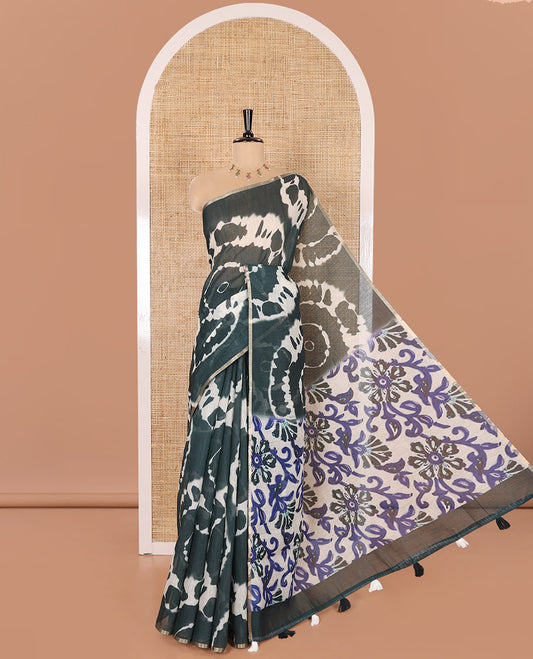 Borderless Green Linen Cotton Saree Accentuated with Shibori Prints, Complemented by Contrast Pallu Steeped with Floral Vine Print, and Paired with a Contrast Floral Printed Blouse