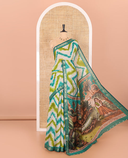 Olive Muslin Cotton Saree Decked Up with Zig-Zag Shibori Patterns Prints, Complemented by a Contrast Border of Deer Motifs in Zari, Pallu Decked Up with Scenery Print, and Paired with a Contrast Polka Dots Printed Blouse