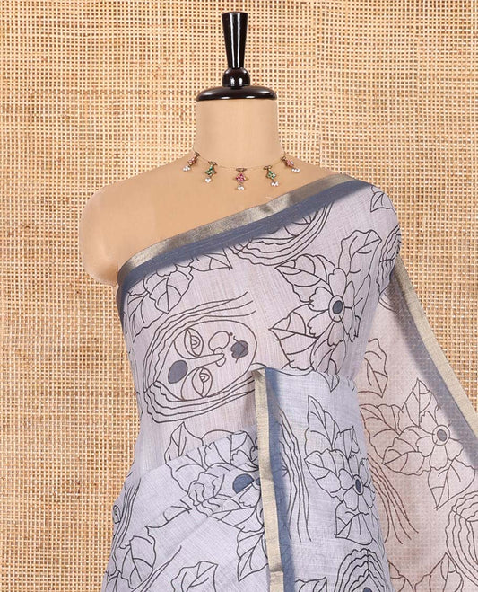 Light Grey Linen Saree Creatively Printed with Girl Face and Floral Motifs All Over Its Body, Subtly Sparkled with Piping Zari Border, Pallu Mirrors the Same Body Print, and Paired with a Contrast Blouse