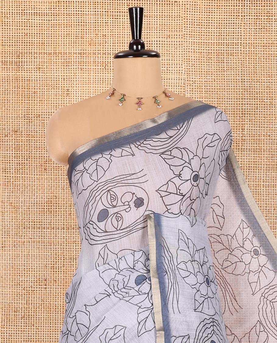 Light Grey Linen Saree Creatively Printed with Girl Face and Floral Motifs All Over Its Body, Subtly Sparkled with Piping Zari Border, Pallu Mirrors the Same Body Print, and Paired with a Contrast Blouse