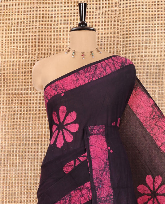 Wine Mul Cotton Saree Detailed with Batik-Style Floral Motifs Printed All Over Its Body, Complemented by a Contrast Batik Printed Border, Pallu Mirrors the Same Batik Print, and Is Paired with a Matching Blouse