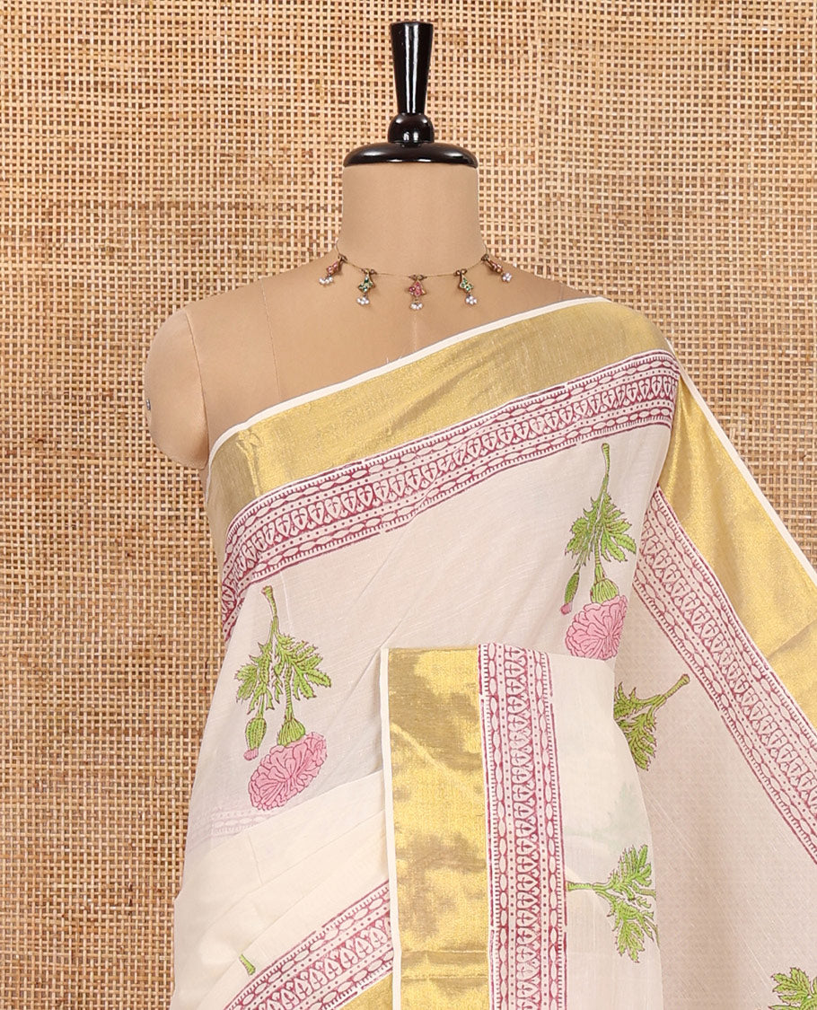 Cream Kerala Cotton Saree, Adorned with Floral Buttas All Over Its Body, Highlighted by Golden Zari Border, Pallu Depicts the Same Floral Print, and Paired with a Matching Floral Printed Blouse