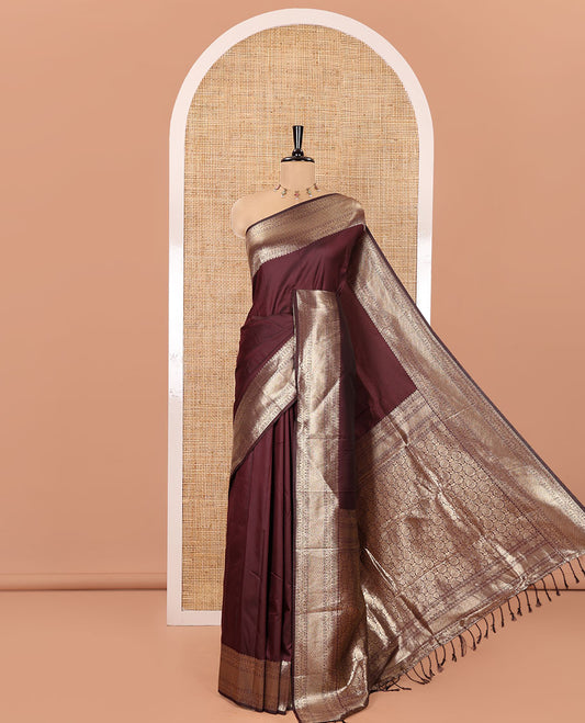 Maroon Plain Semi-Soft Silk Saree, Highlighted by Traditional Zari Designs Woven Border, Grandly Woven Pallu Steeped with Chakram Designs, and Paired with a Matching Blouse