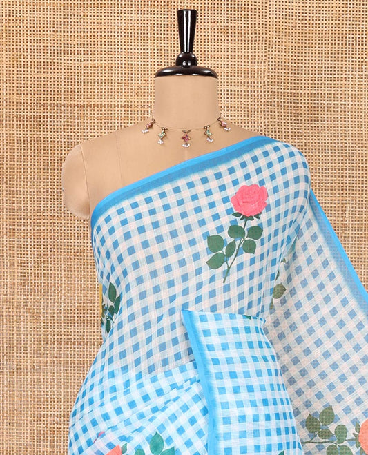 Borderless blue linen Cotton Saree, Graced with Rose Floral Buttas and Checked Design on Its Body, Pallu Pictures a Beautiful Rose Floral Motifs, and Paired with a Matching Blouse