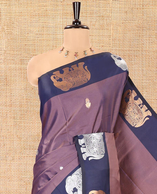Lavender Soft Silk Saree, Elevated With Zari Buttas All Over Its Body, Complemented by Captivating Contrast Border of Elephant Motifs, Grandly Decked Up Pallu, and Paired with a Contrast Blouse