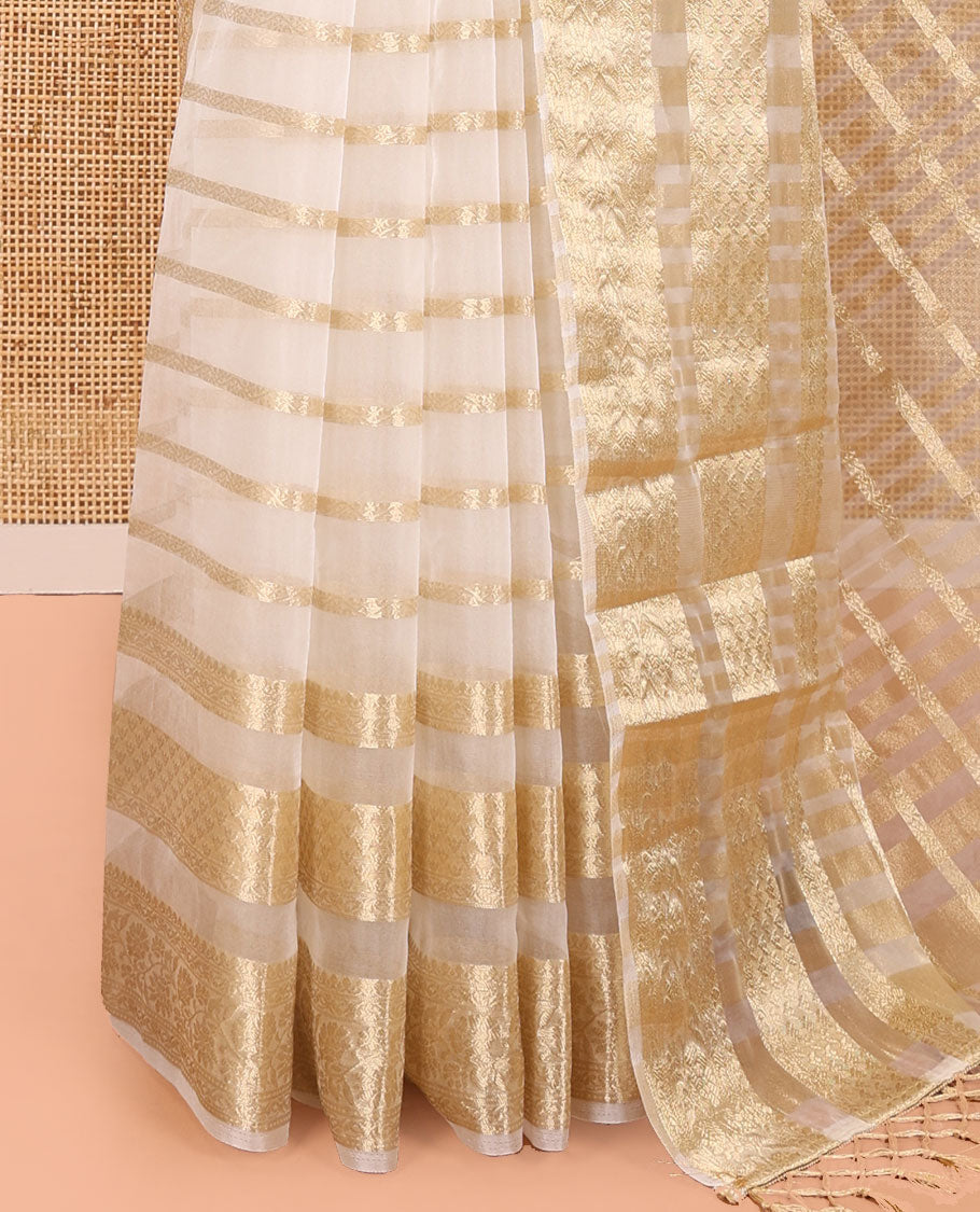 Cream Semi-Organza Saree, Steeped in Richness of Horizontal Zari Stripes All Over Its Body, Highlighted by a Traditional Zari Design Border, Gleaming Zari Design Pallu, and Paired with a Matching Blouse