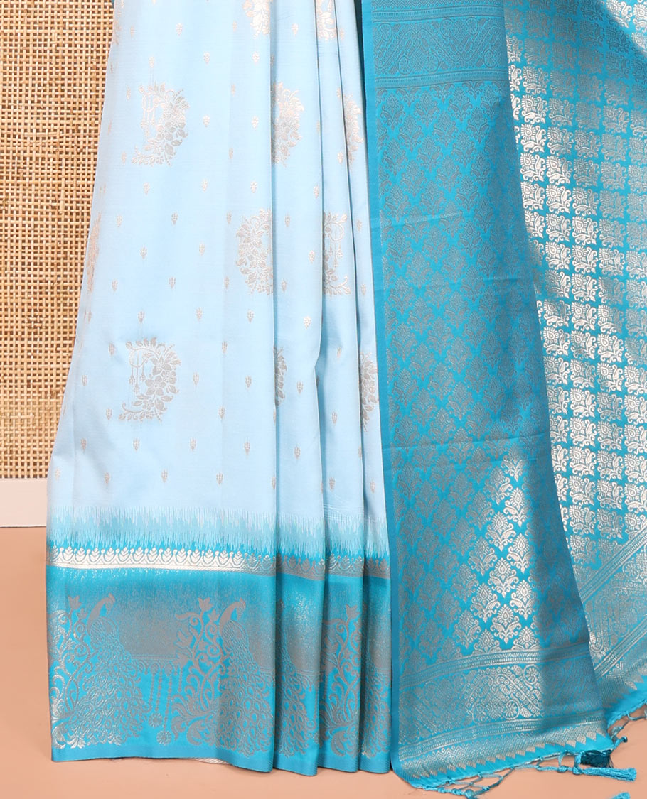 Sky Blue Elite Soft Silk Saree, Showcasing Zari Buttas on Its Body, Complemented by a Contrast Peacock-Floral Zari Blouse, Intricately Designed Pallu, and Paired with a Contrast Blouse