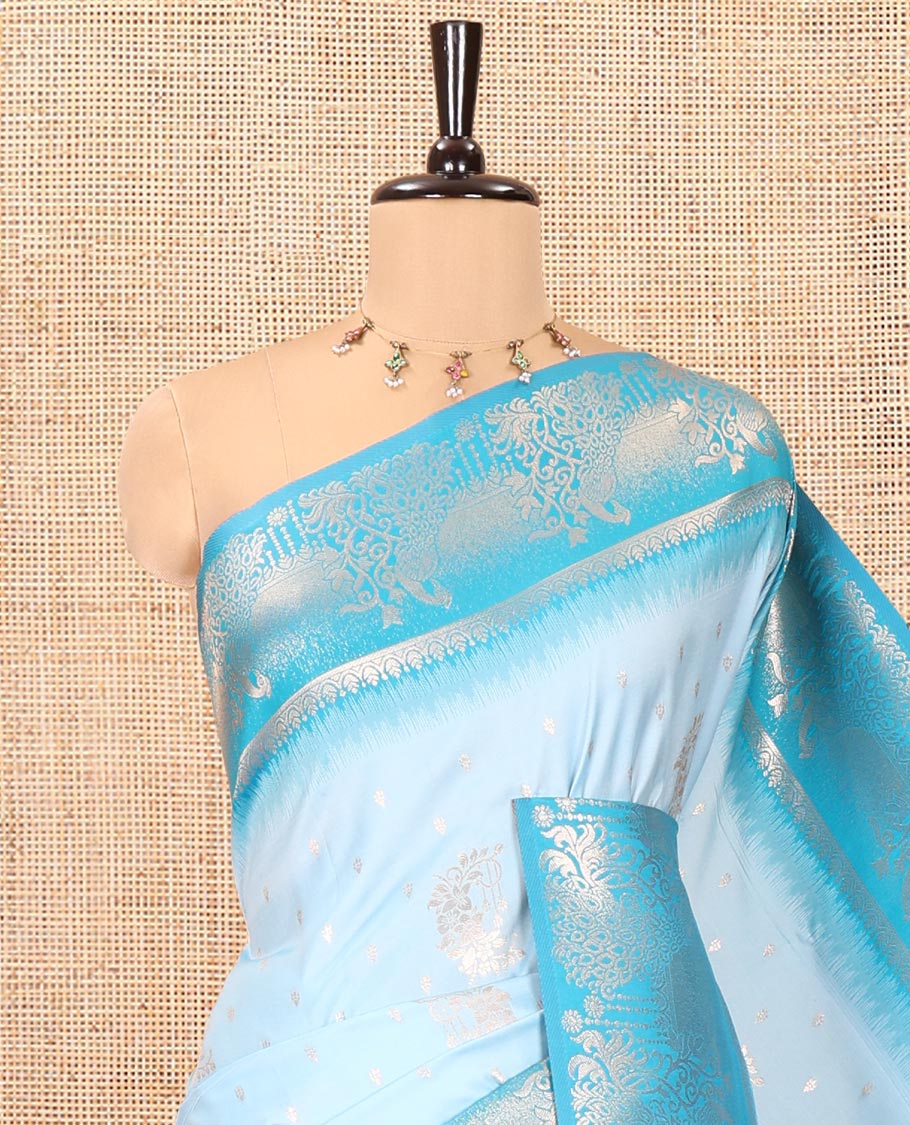 Sky Blue Elite Soft Silk Saree, Showcasing Zari Buttas on Its Body, Complemented by a Contrast Peacock-Floral Zari Blouse, Intricately Designed Pallu, and Paired with a Contrast Blouse