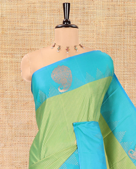 Parrot Green Kanchi Soft Silk Saree, Majestically Detailed with Vaira Oosi, and Zari Buttas All Over Its Body, Complemented by Contrast Border of Paisleys, an Intricately Designed Pallu, and Paired with a Contrast Blouse